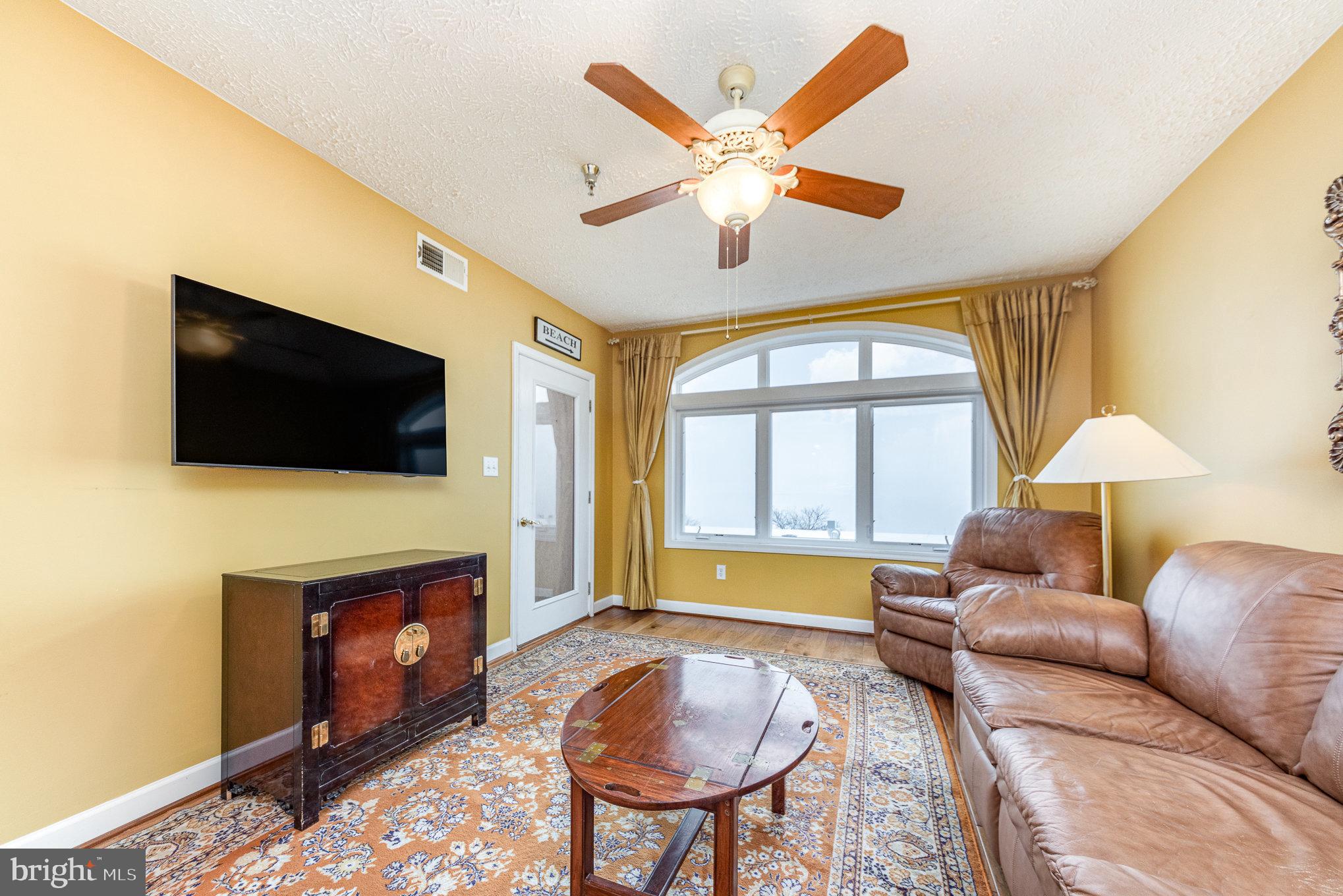 100 Taylor Street, Unit 505 Colonial Beach, VA 22443 - Photo 15 of 22 a living room with furniture a flat screen tv and a fireplace