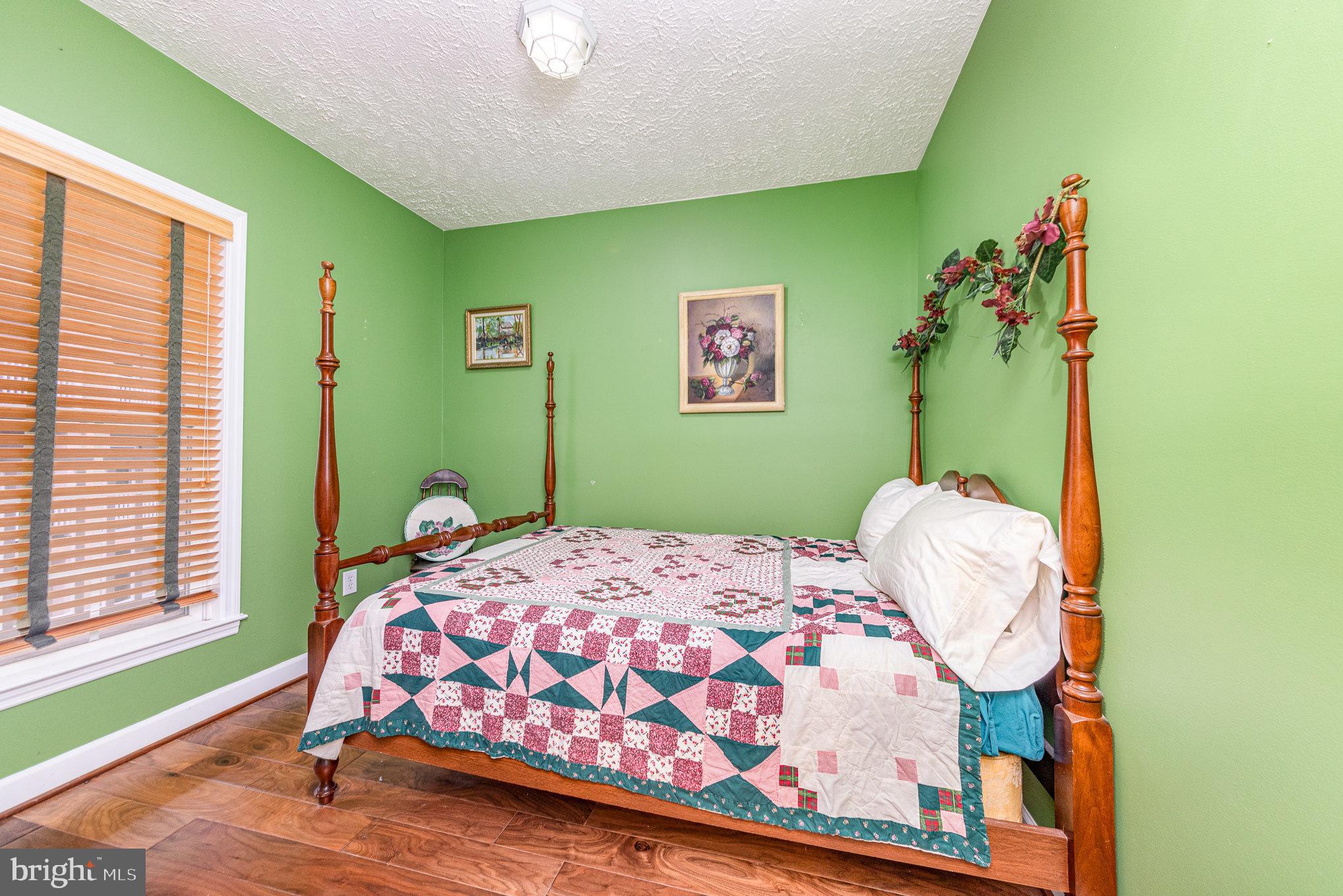 100 Taylor Street, Unit 505 Colonial Beach, VA 22443 - Photo 19 of 22 a bedroom with a bed and a window