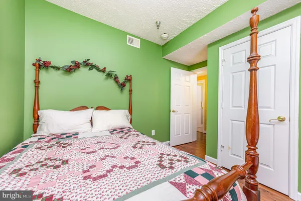 a bedroom with a bed and a dresser