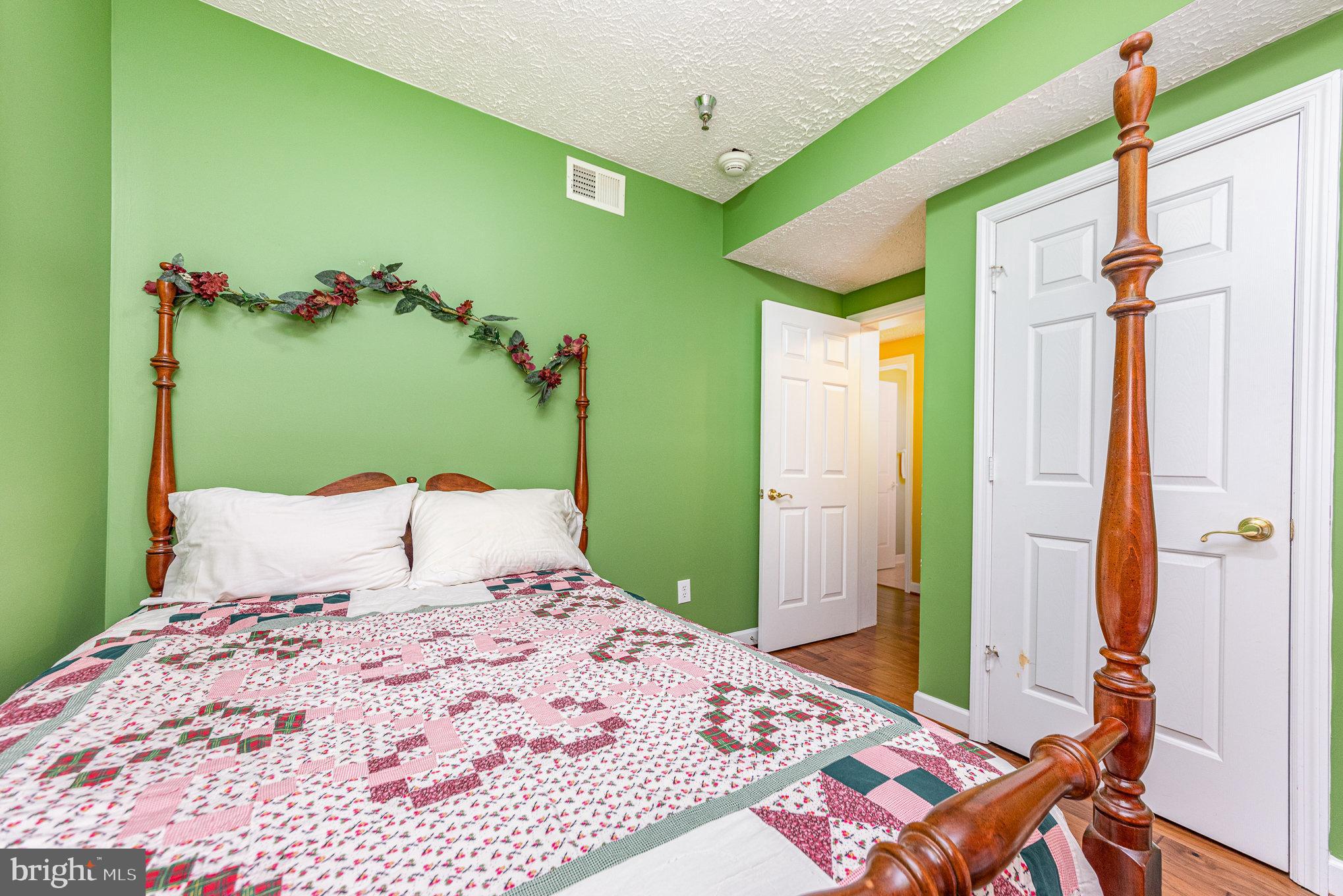 100 Taylor Street, Unit 505 Colonial Beach, VA 22443 - Photo 20 of 22 a bedroom with a bed and a dresser