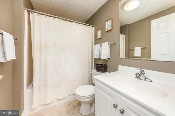 a bathroom with a sink vanity mirror and toilet