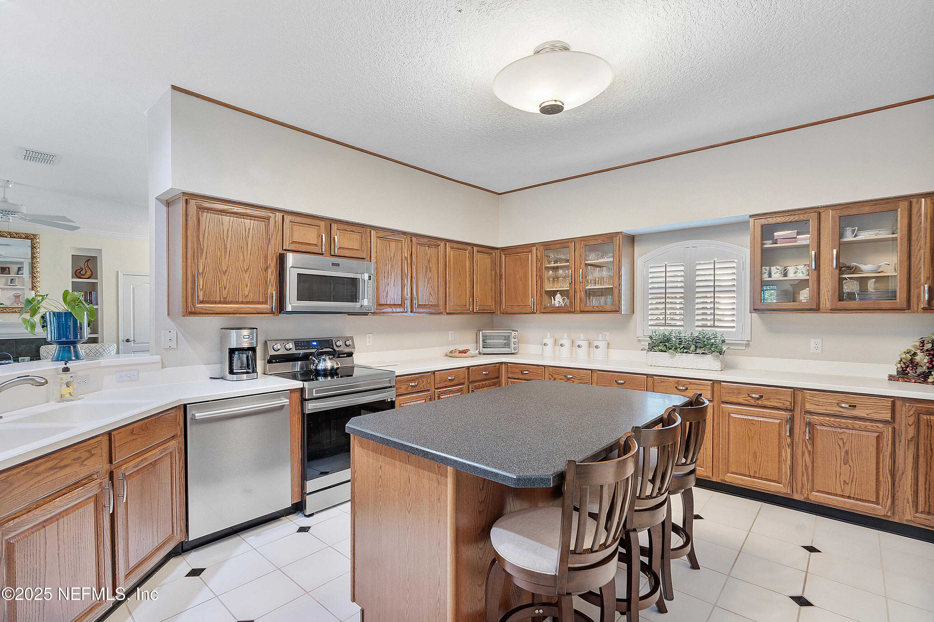 2688 Seneca Drive St. Johns, FL 32259 - Photo 14 of 62 a kitchen with a stove a sink dishwasher a dining table and chairs with wooden floor