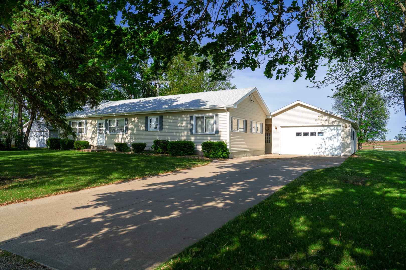 2056 Peek Home Road Dixon, IL 61021 - Photo 1 of 47 a view of a house next to a yard with big trees