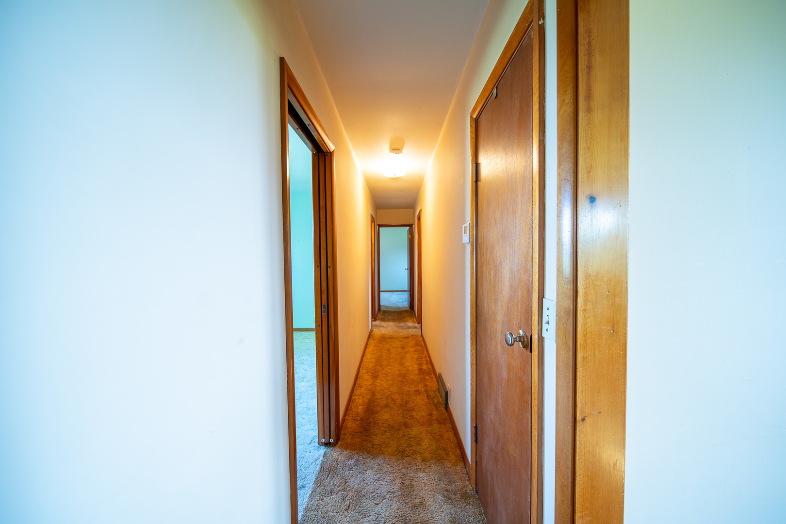 2056 Peek Home Road Dixon, IL 61021 - Photo 13 of 47 a view of a hallway with wooden floor and door in a bathroom