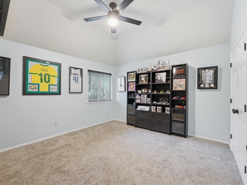 4008 Falcon Ridge Drive Haltom City, TX 76137 - Photo 28 of 40 Carpeted room featuring a ceiling fan with integrated lighting, and a window with blinds