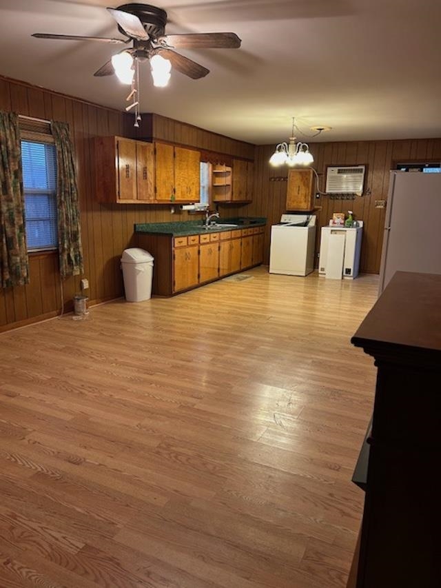 7030 Asbury Glimp Road Ripley, TN 38063 - Photo 12 of 22 Kitchen with dark countertops, brown cabinets, white appliances, a ceiling fan, and wood walls