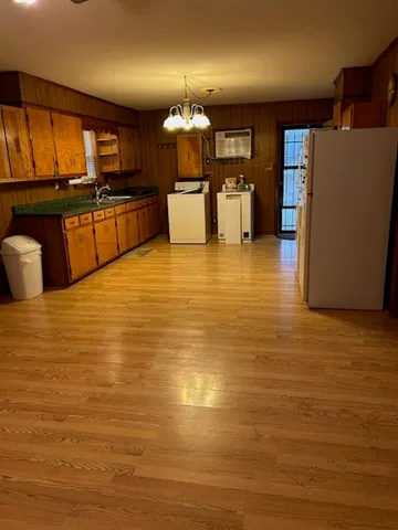 a kitchen with stainless steel appliances a refrigerator a stove top oven a sink and dishwasher