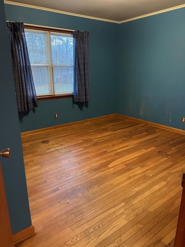 7030 Asbury Glimp Road Ripley, TN 38063 - Photo 19 of 22 Empty room with ornamental molding and hardwood / wood-style floors