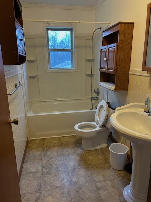 7030 Asbury Glimp Road Ripley, TN 38063 - Photo 20 of 22 Bathroom with tile walls, tub / shower combination, and wainscoting