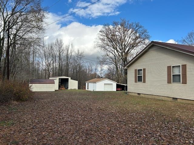 7030 Asbury Glimp Road Ripley, TN 38063 - Photo 5 of 22 View of yard with an outbuilding and a garage