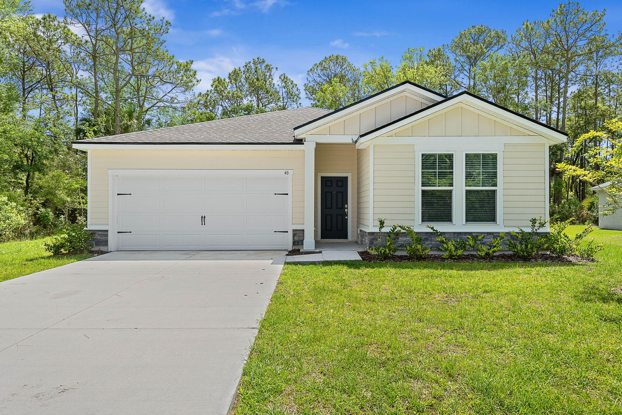 46 Poplar Drive Palm Coast, FL 32164 - Photo 1 of 59 a view of a house with garden and yard