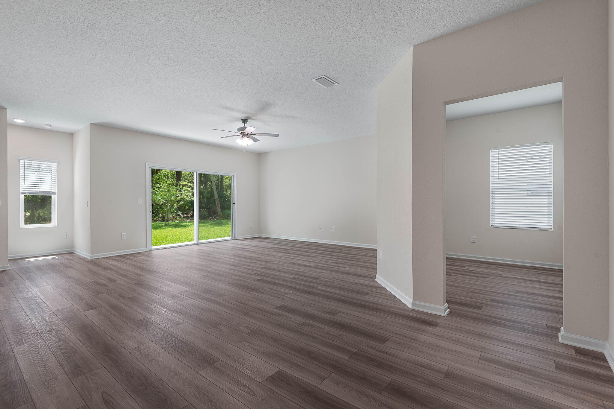 46 Poplar Drive Palm Coast, FL 32164 - Photo 12 of 59 a view of an empty room with a window and wooden floor