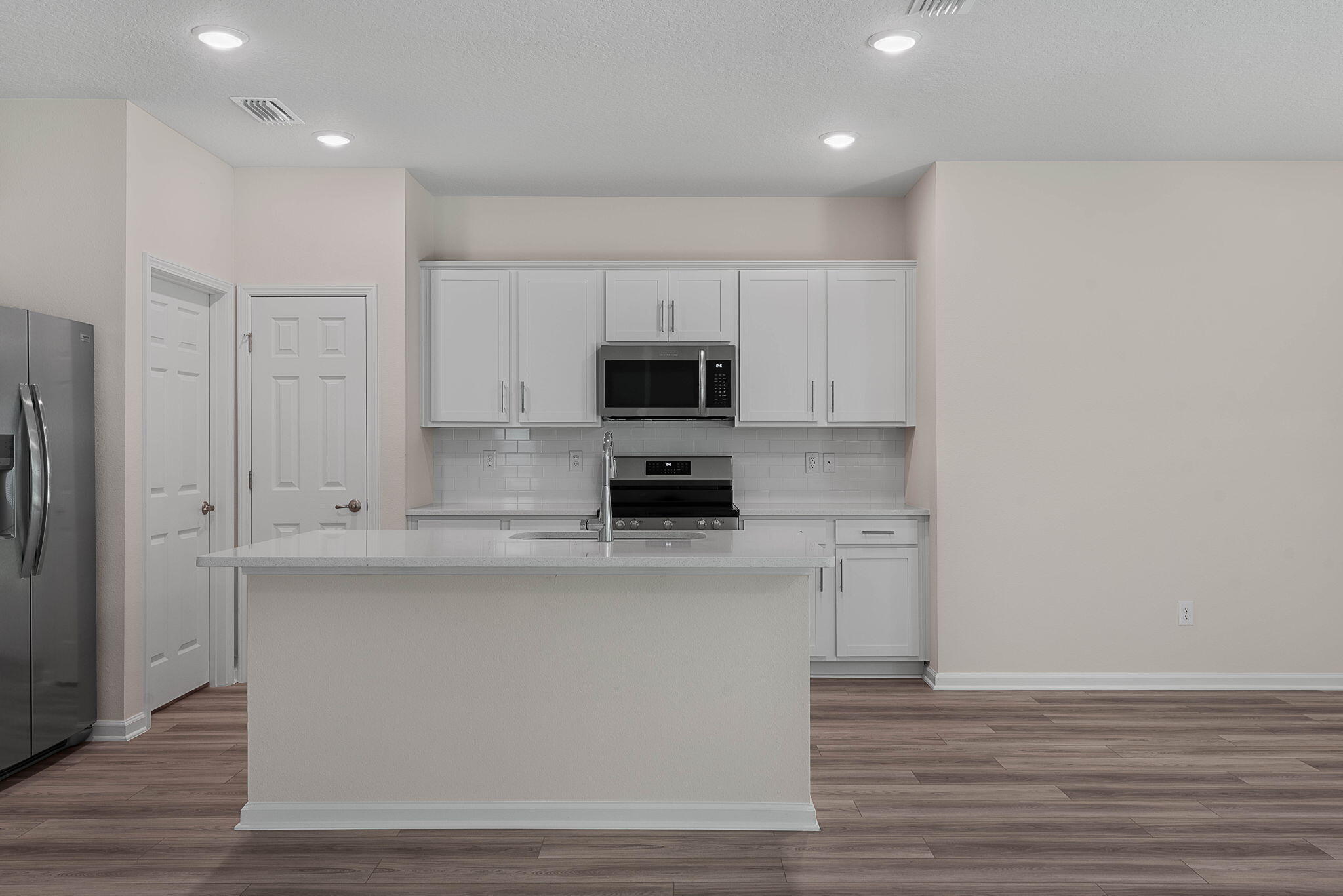 46 Poplar Drive Palm Coast, FL 32164 - Photo 16 of 59 a kitchen with kitchen island a sink appliances and cabinets