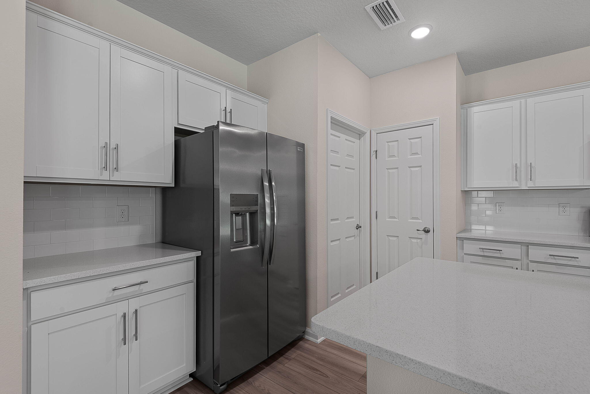 46 Poplar Drive Palm Coast, FL 32164 - Photo 22 of 59 a kitchen with stainless steel appliances white cabinets and a refrigerator