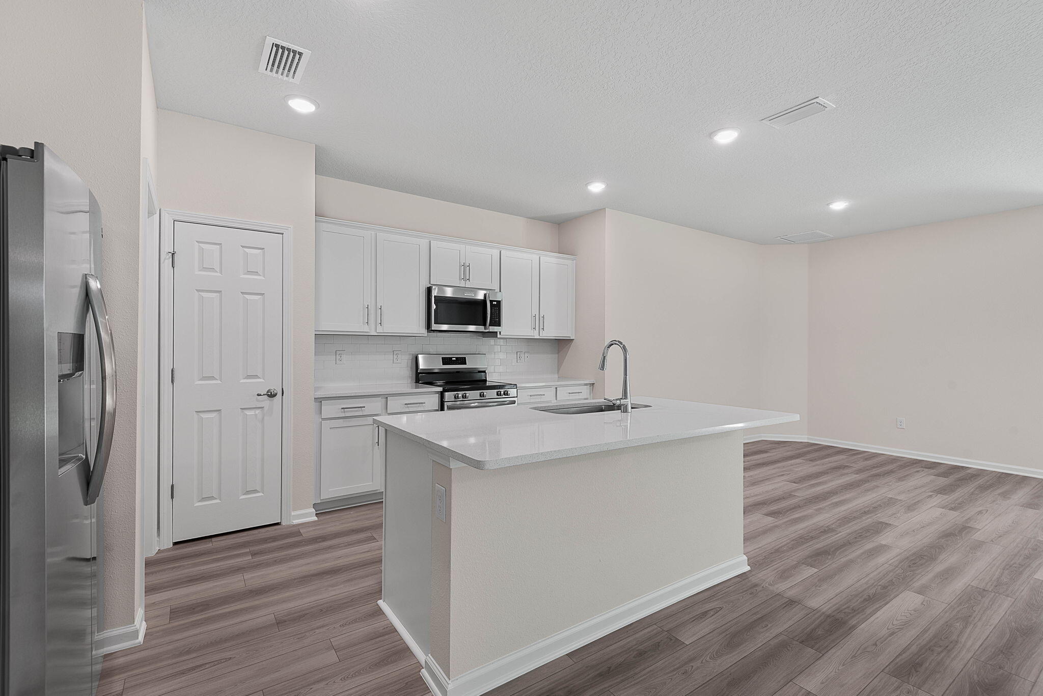 46 Poplar Drive Palm Coast, FL 32164 - Photo 23 of 59 a kitchen with stainless steel appliances a sink stove and refrigerator