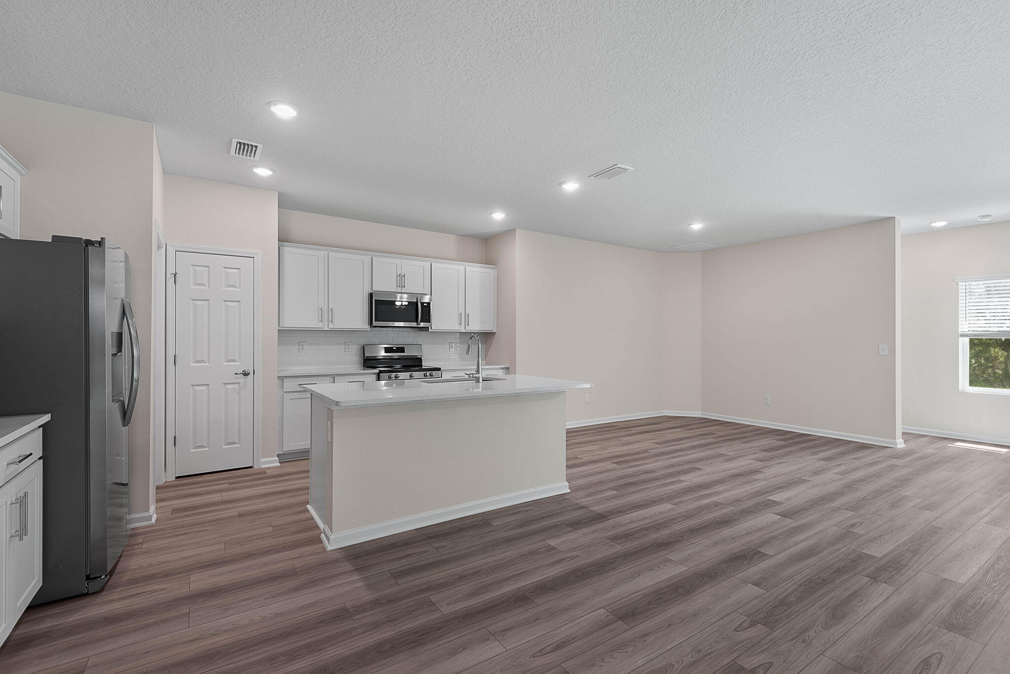 46 Poplar Drive Palm Coast, FL 32164 - Photo 24 of 59 a view of kitchen with granite countertop stainless steel appliances cabinets and wooden floor