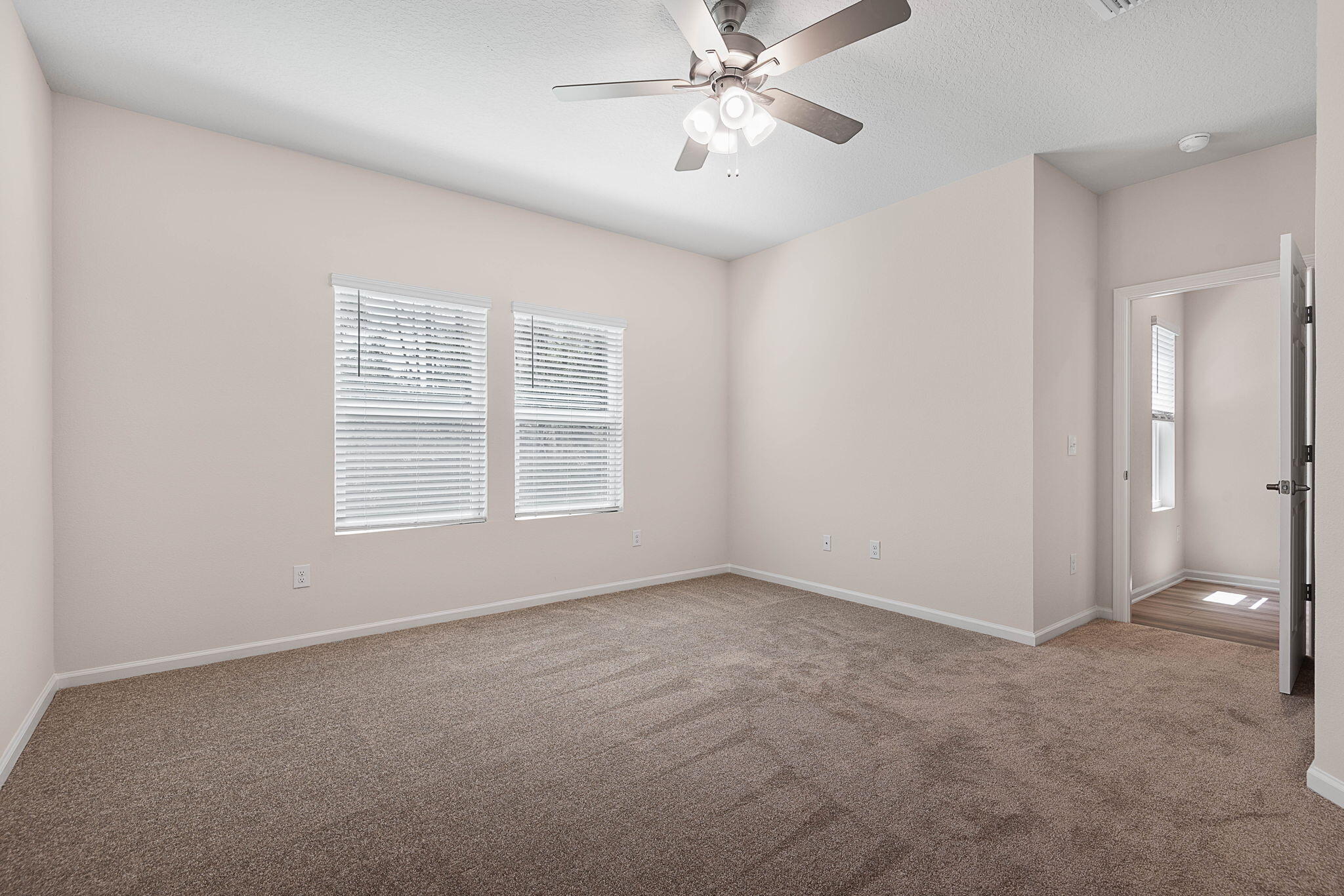 46 Poplar Drive Palm Coast, FL 32164 - Photo 27 of 59 an empty room with windows and fan