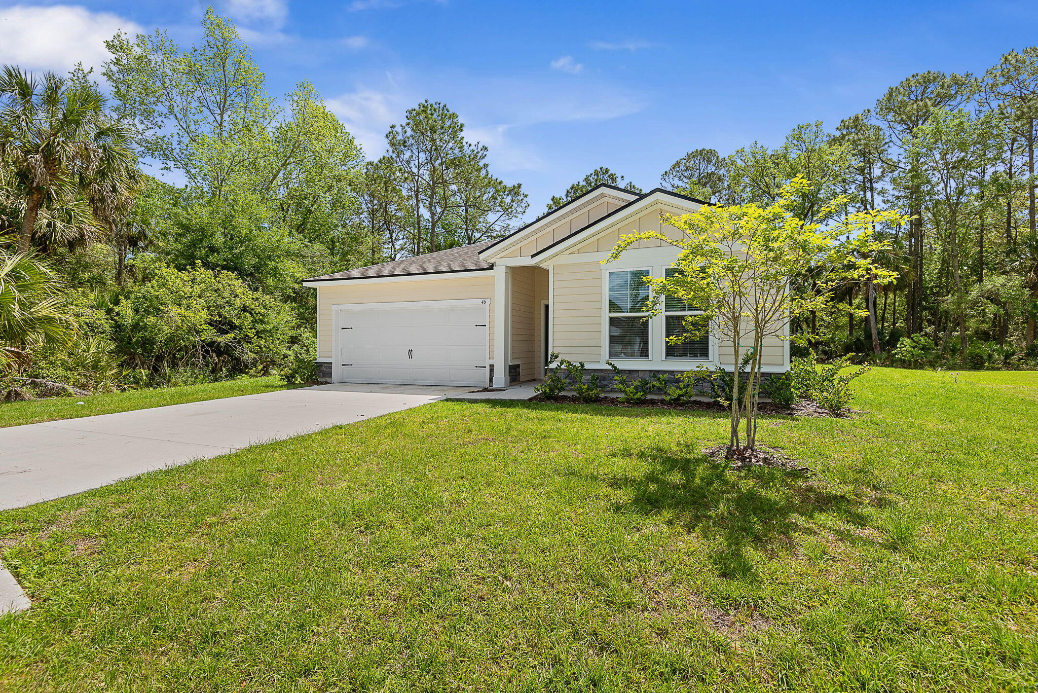 46 Poplar Drive Palm Coast, FL 32164 - Photo 3 of 59 a house with trees in the background