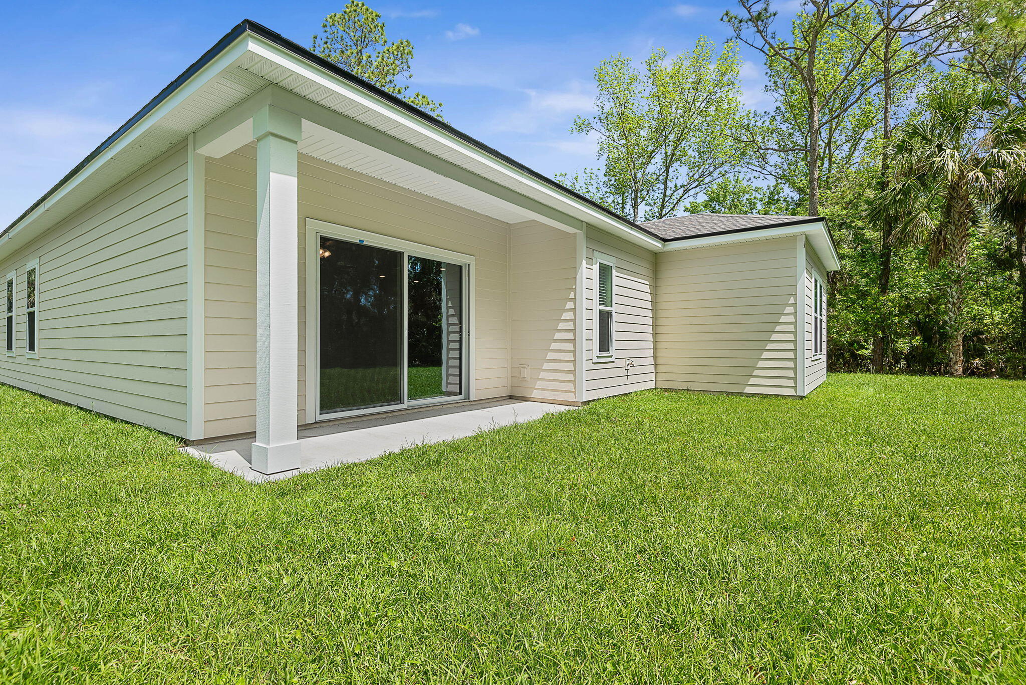 46 Poplar Drive Palm Coast, FL 32164 - Photo 49 of 59 a front view of a house with a garden