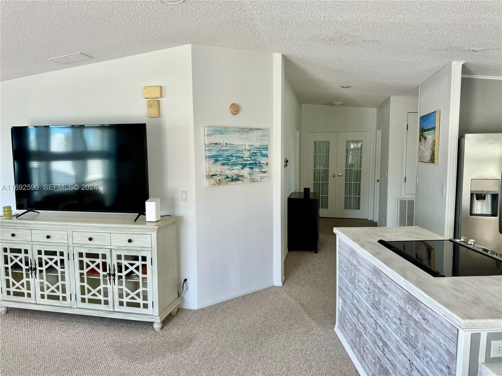 72 Ocean Drive Key Largo, FL 33037 - Photo 11 of 36 a living room with furniture and a flat screen tv
