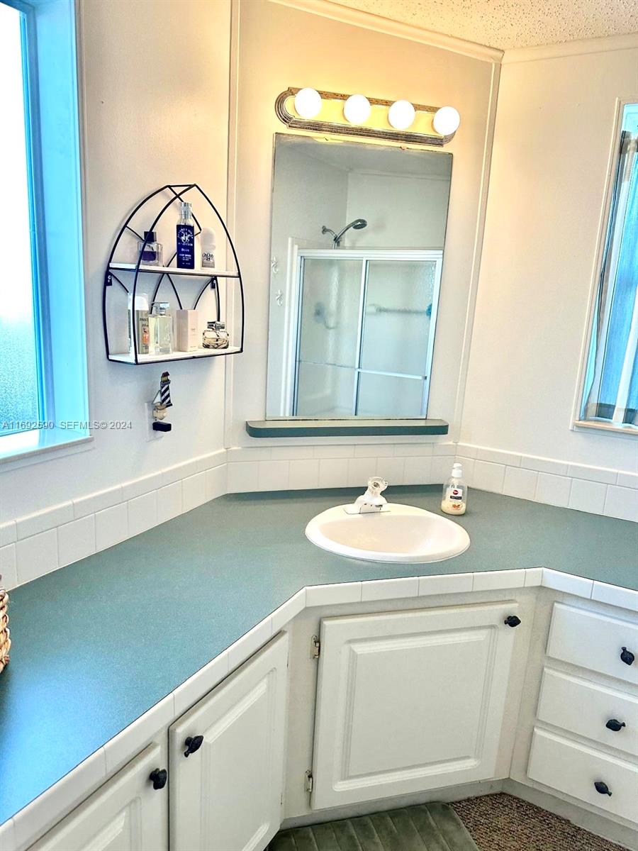 72 Ocean Drive Key Largo, FL 33037 - Photo 13 of 36 a bathroom with a sink and a mirror