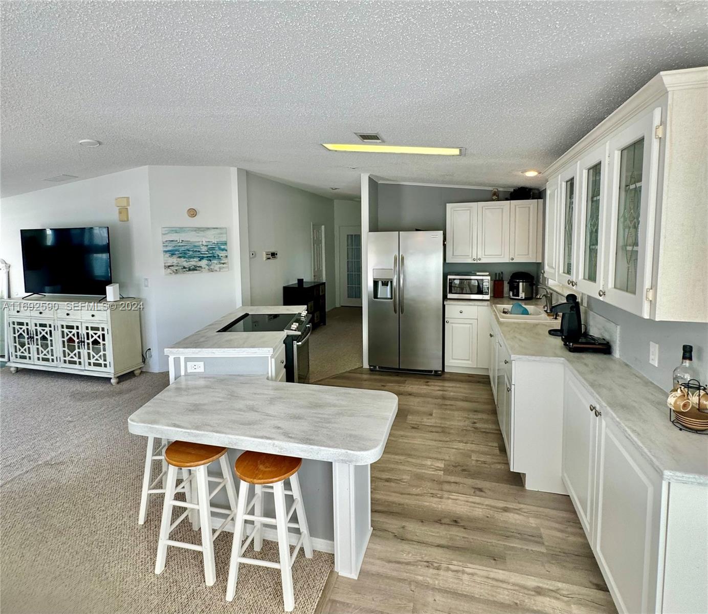 72 Ocean Drive Key Largo, FL 33037 - Photo 18 of 36 a kitchen with stainless steel appliances kitchen island granite countertop a stove refrigerator and microwave