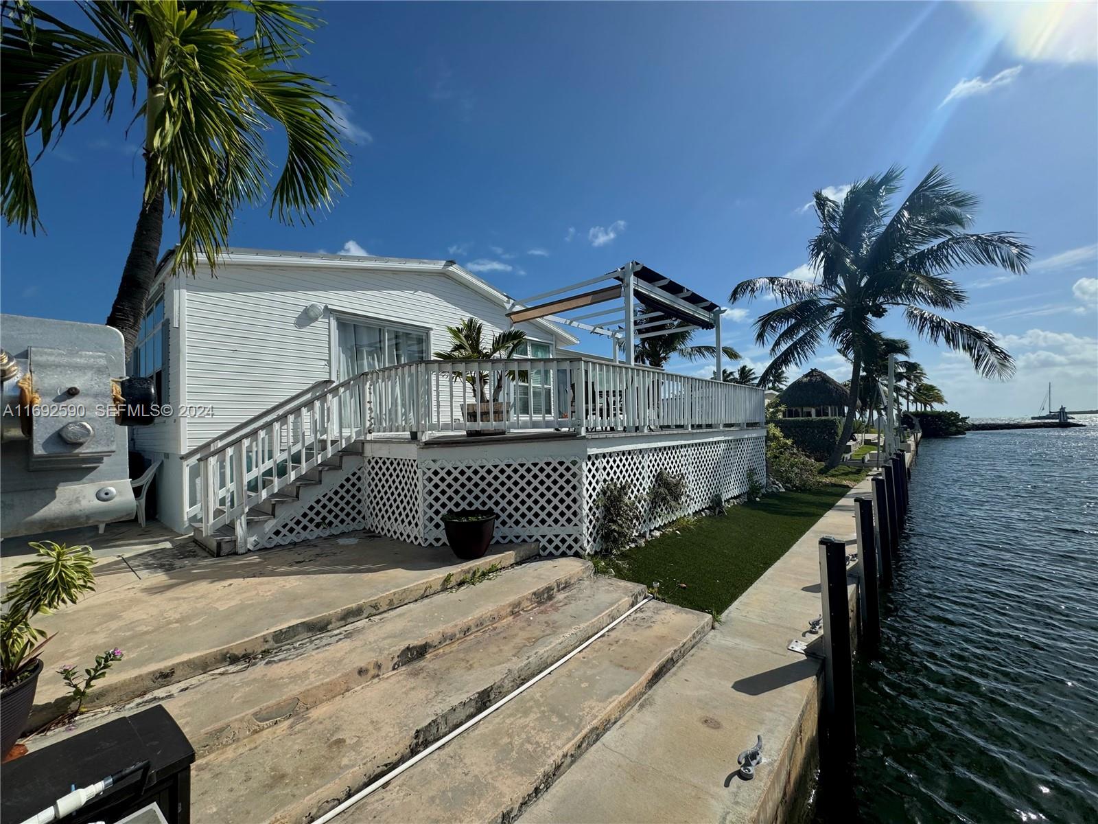 72 Ocean Drive Key Largo, FL 33037 - Photo 20 of 36 a view of a house with a wooden deck