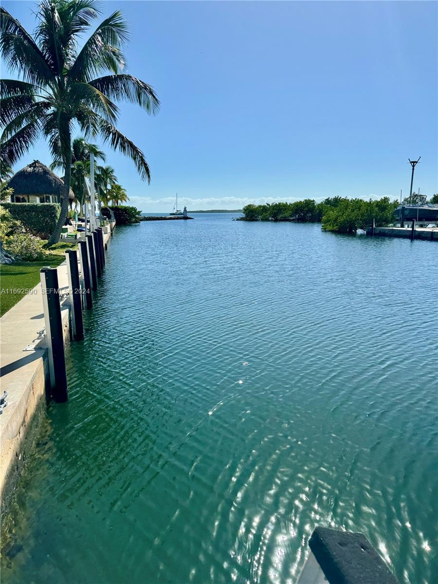72 Ocean Drive Key Largo, FL 33037 - Photo 2 of 36 a view of a lake with houses in the back
