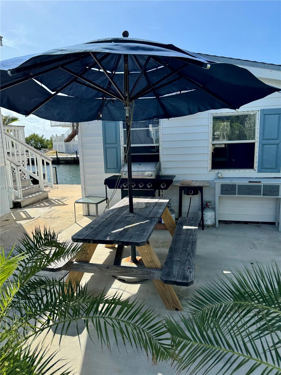 72 Ocean Drive Key Largo, FL 33037 - Photo 21 of 36 a patio with tables and chairs