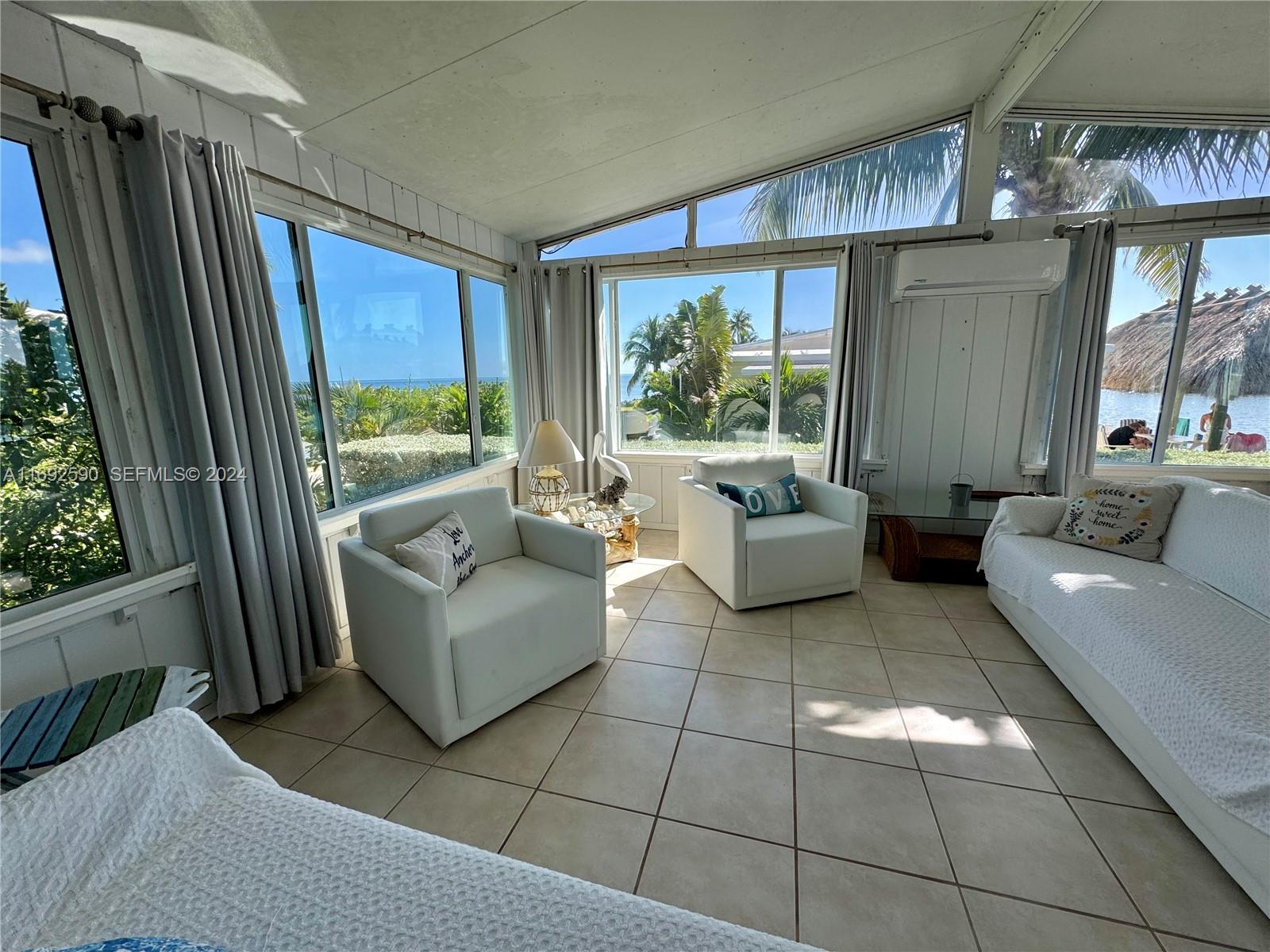 72 Ocean Drive Key Largo, FL 33037 - Photo 23 of 36 a living room with furniture and a large window