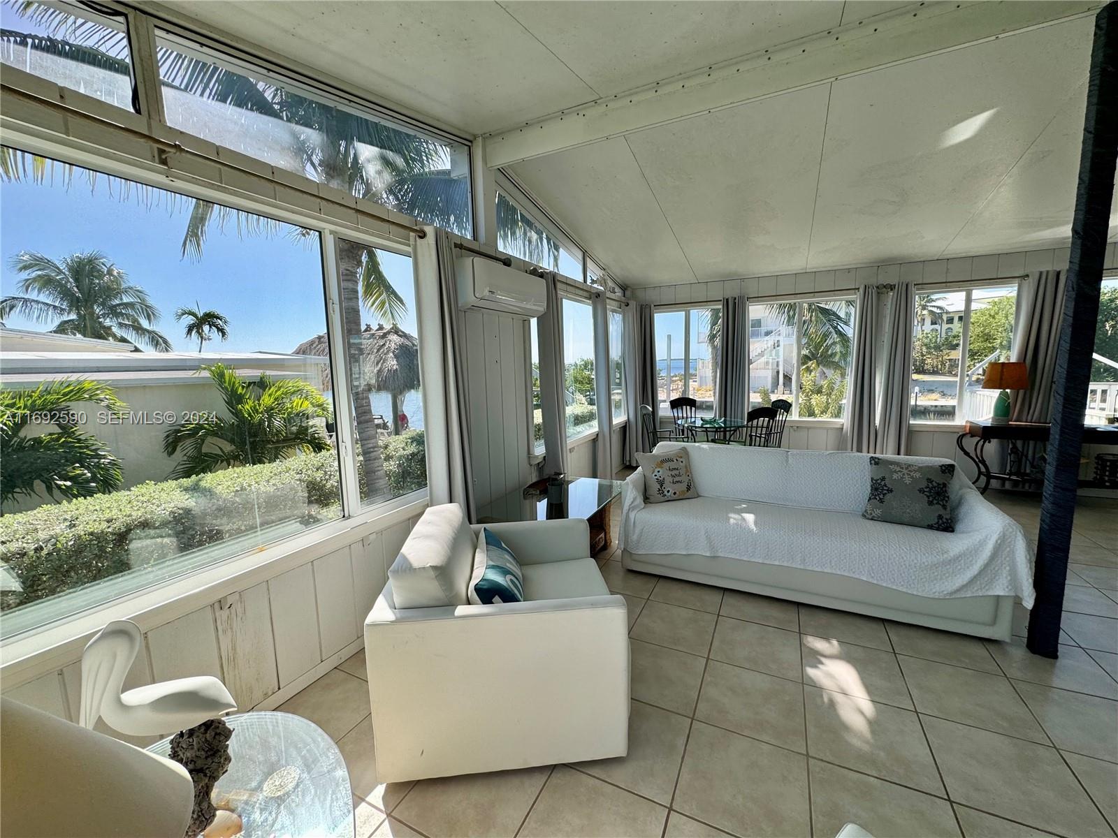 72 Ocean Drive Key Largo, FL 33037 - Photo 24 of 36 a living room with furniture and a large window