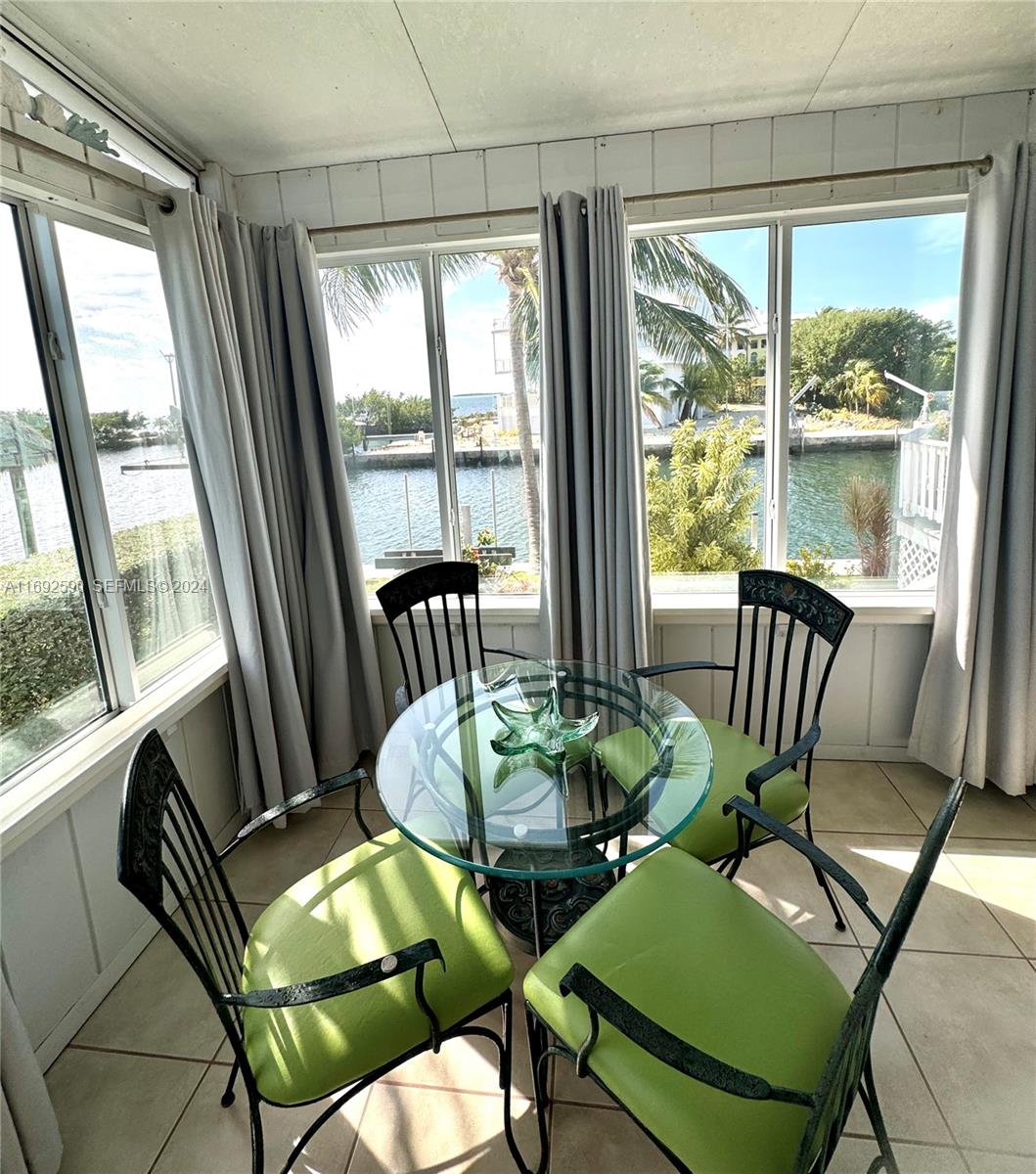 72 Ocean Drive Key Largo, FL 33037 - Photo 25 of 36 a view of a dining room with furniture window and outside view