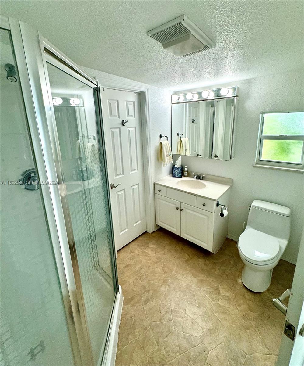 72 Ocean Drive Key Largo, FL 33037 - Photo 26 of 36 a bathroom with a sink a toilet a mirror and tub