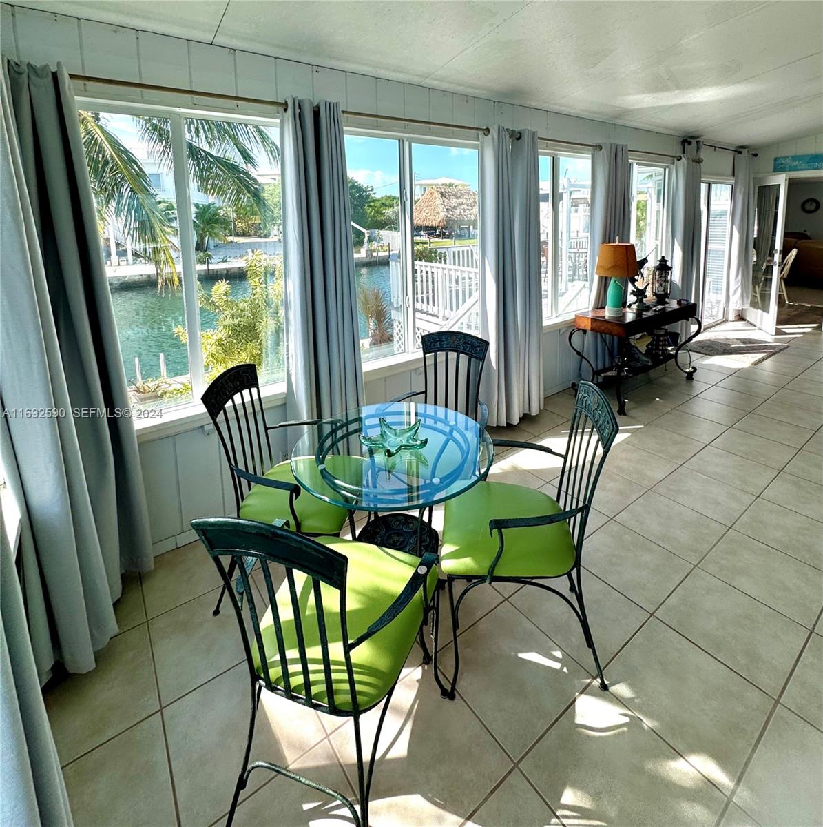 72 Ocean Drive Key Largo, FL 33037 - Photo 28 of 36 a view of a dining room with furniture window and outside view