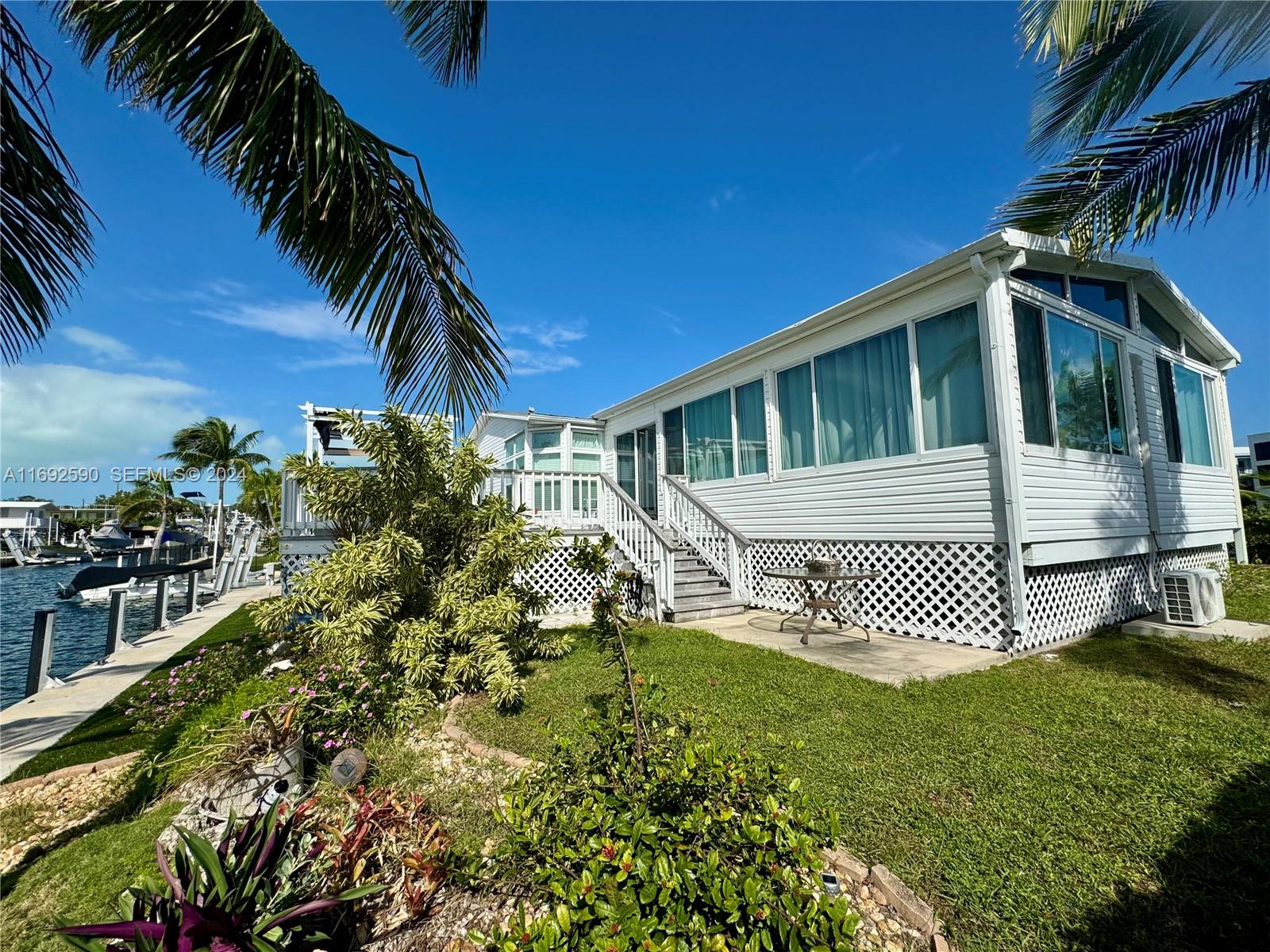 72 Ocean Drive Key Largo, FL 33037 - Photo 31 of 36 a front view of a house with a yard