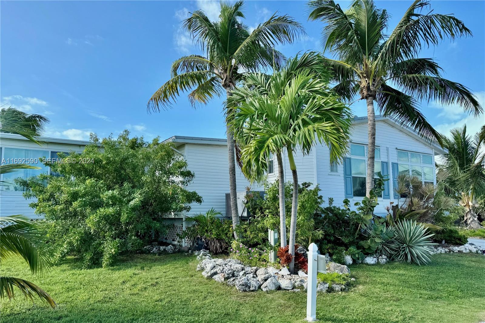 72 Ocean Drive Key Largo, FL 33037 - Photo 35 of 36 a view of a palm trees in front of a house