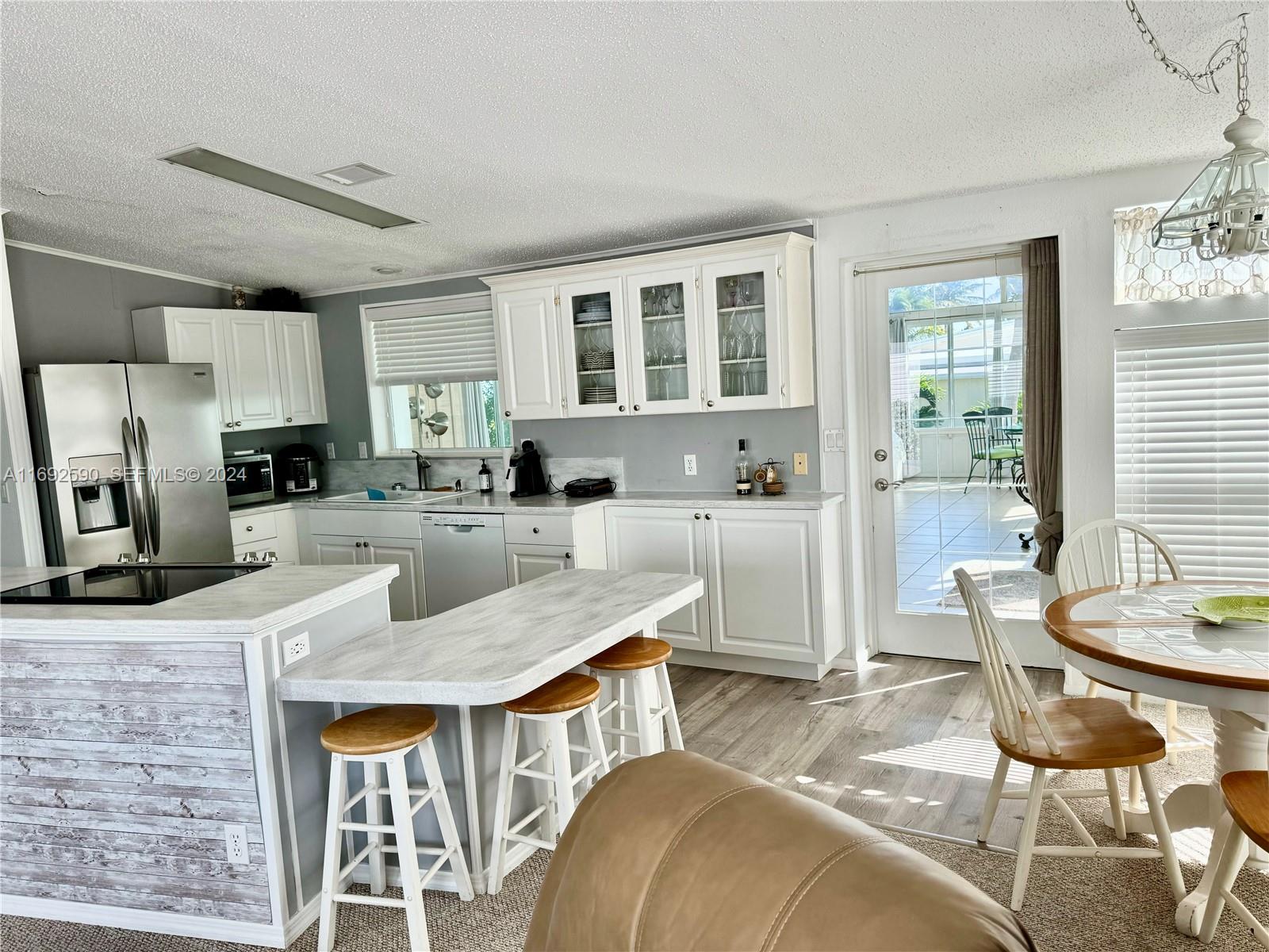 72 Ocean Drive Key Largo, FL 33037 - Photo 5 of 36 a living room with stainless steel appliances kitchen island granite countertop furniture and a kitchen view