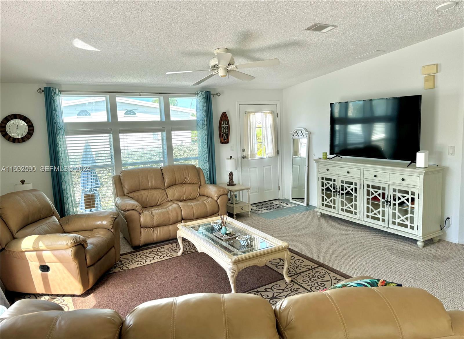72 Ocean Drive Key Largo, FL 33037 - Photo 9 of 36 a living room with furniture and a flat screen tv