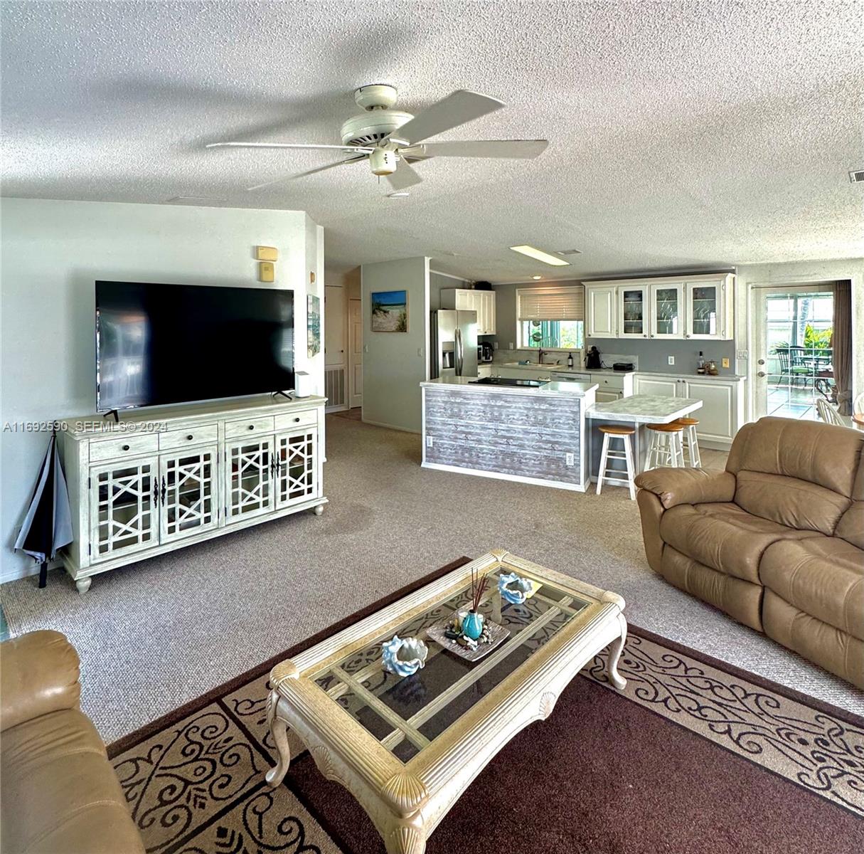 72 Ocean Drive Key Largo, FL 33037 - Photo 10 of 36 a living room with furniture and a flat screen tv