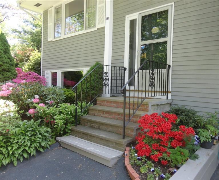 131 Old Kings Road Cotuit, MA 02635 - Photo 1 of 33 a view of a house with a flower garden