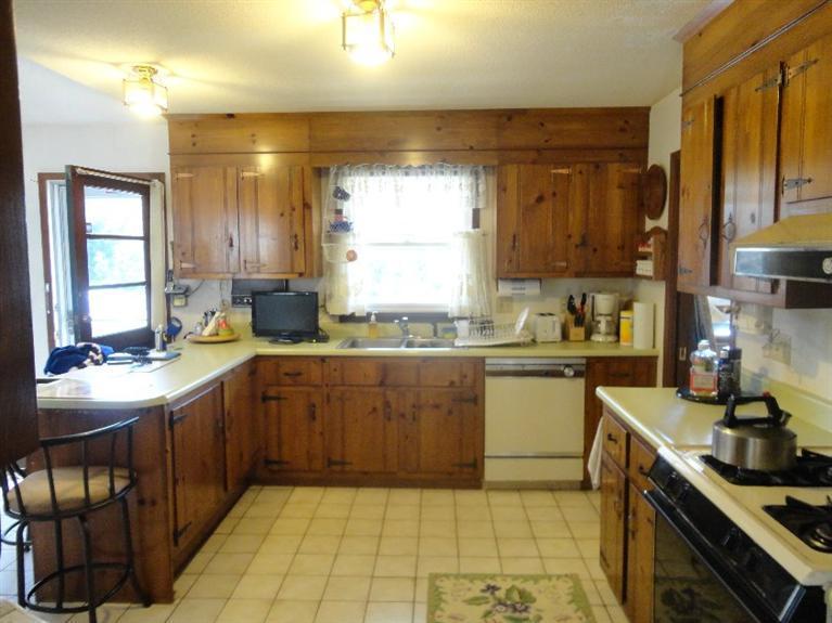 131 Old Kings Road Cotuit, MA 02635 - Photo 12 of 33 a kitchen with a sink window and cabinets