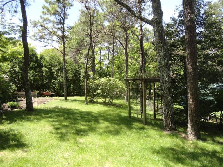 131 Old Kings Road Cotuit, MA 02635 - Photo 24 of 33 a backyard of a house with swimming pool and trees