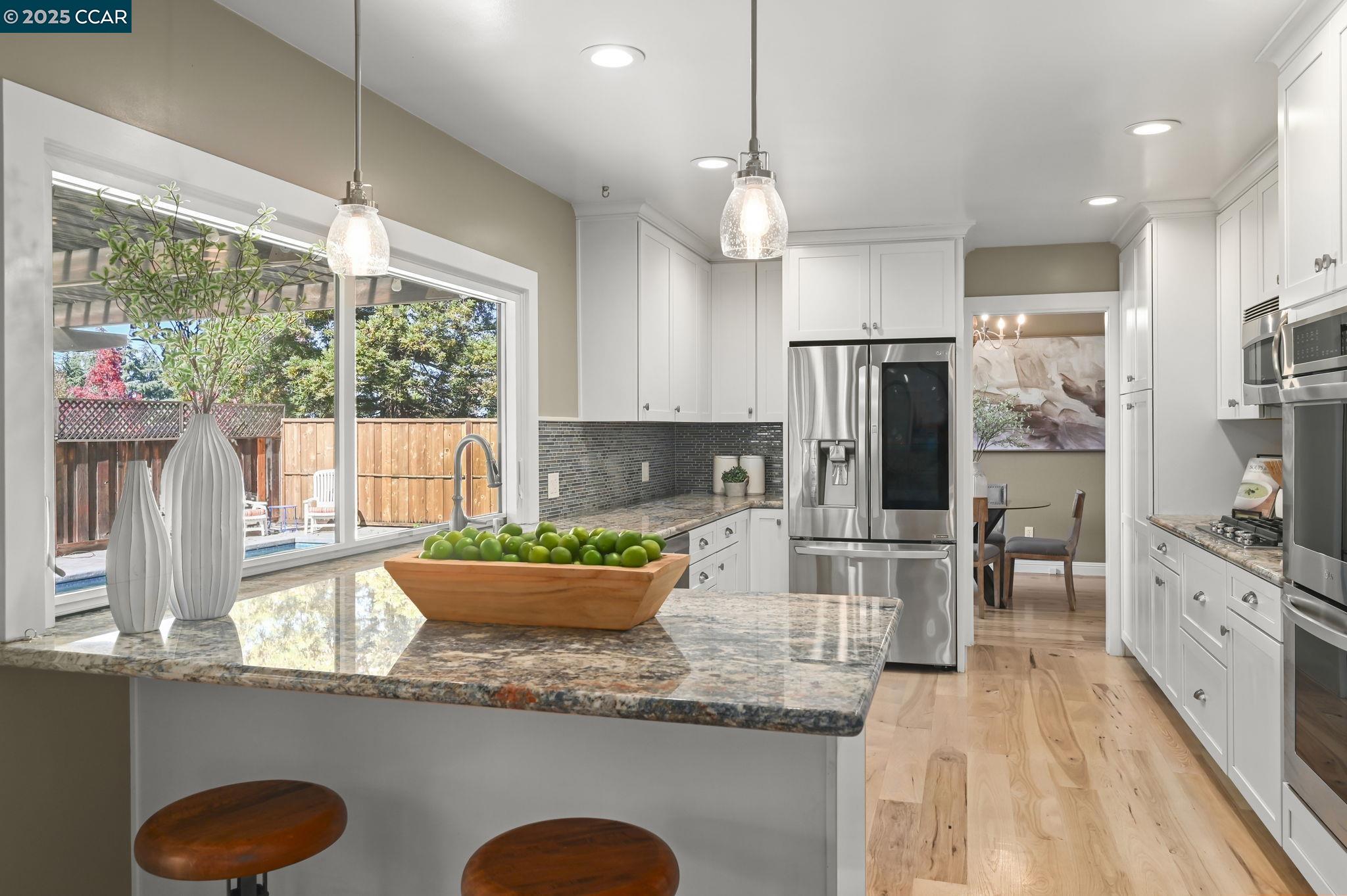 7 Atchinson Stage Road Clayton, CA 94517 - Photo 11 of 37 a kitchen with stainless steel appliances granite countertop a stove refrigerator and microwave