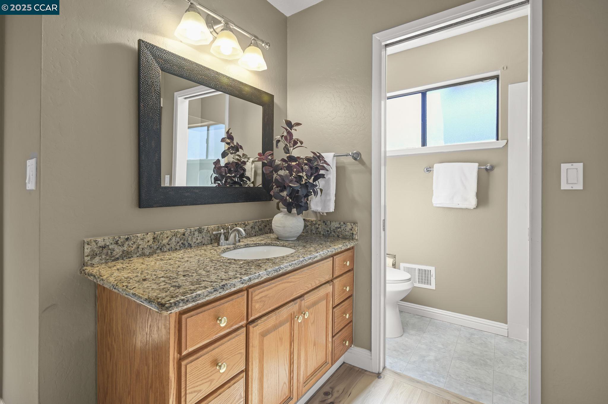 7 Atchinson Stage Road Clayton, CA 94517 - Photo 21 of 37 a bathroom with a granite countertop sink and a mirror