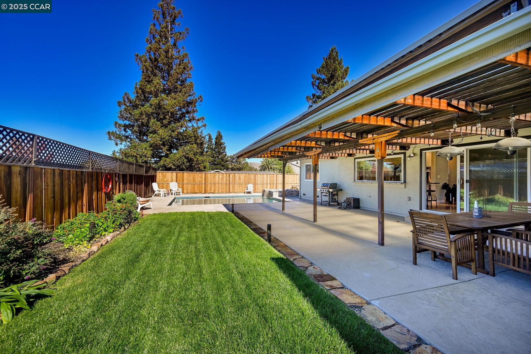 7 Atchinson Stage Road Clayton, CA 94517 - Photo 25 of 37 a view of backyard with table and chairs and potted plants