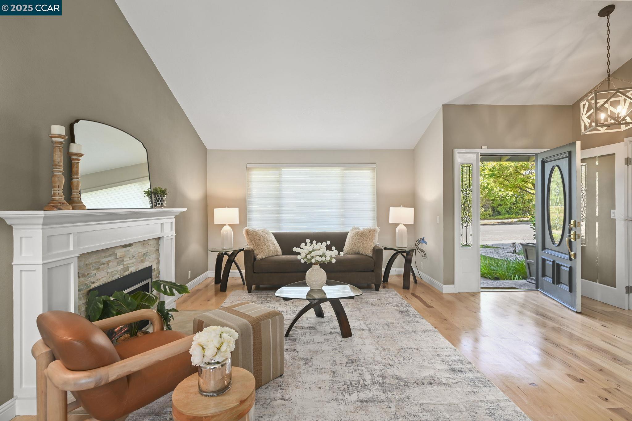 7 Atchinson Stage Road Clayton, CA 94517 - Photo 6 of 37 a living room with furniture a fireplace and a large window