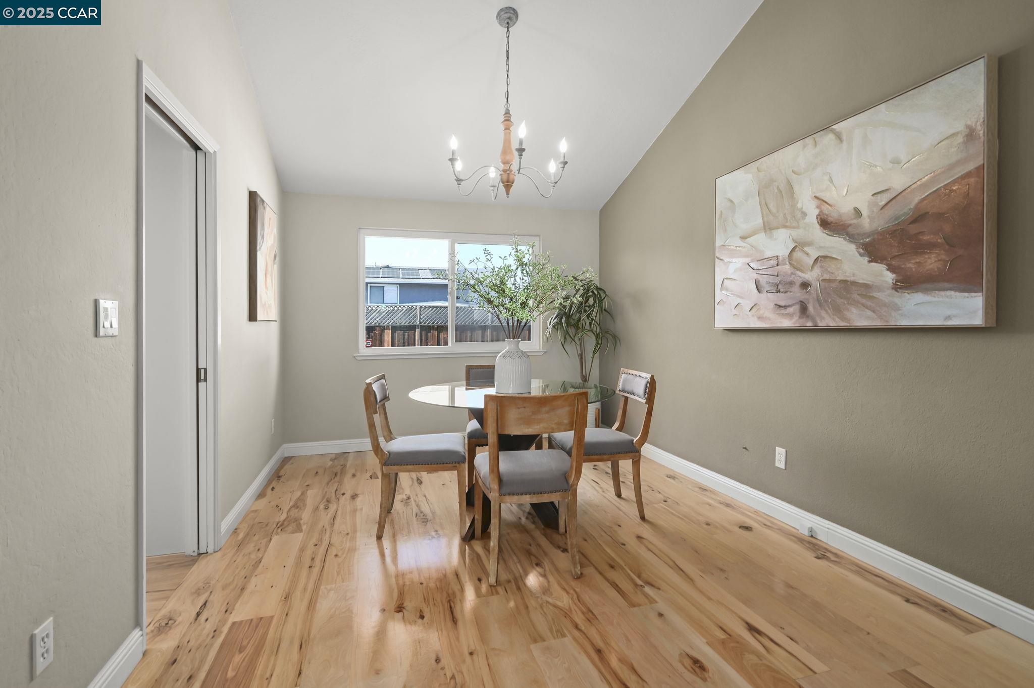 7 Atchinson Stage Road Clayton, CA 94517 - Photo 8 of 37 a dining room with wooden floor and a chandelier