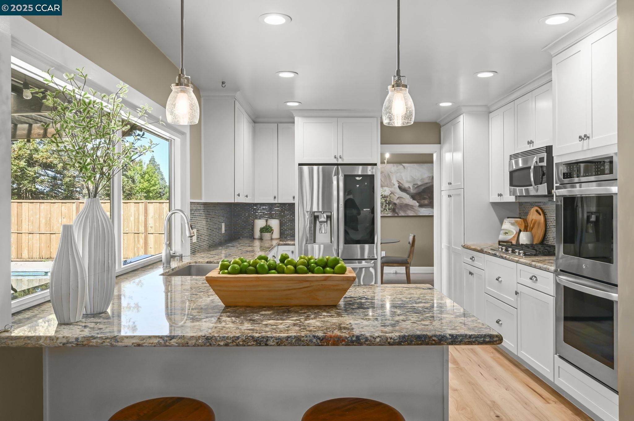 7 Atchinson Stage Road Clayton, CA 94517 - Photo 10 of 37 a kitchen with kitchen island granite countertop a large window and stainless steel appliances