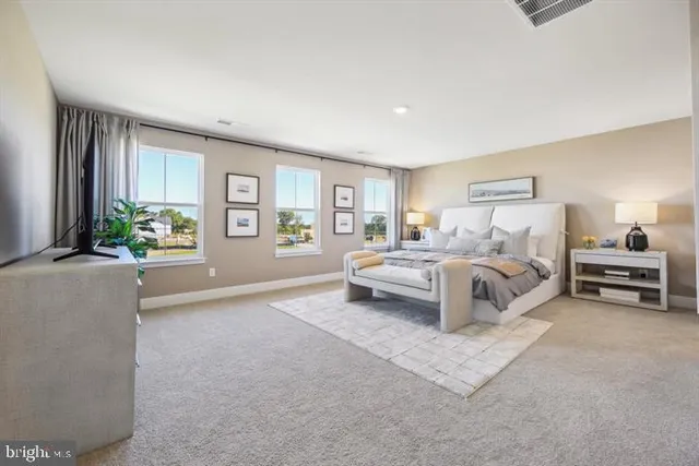 a bedroom with a bed lamp and a window