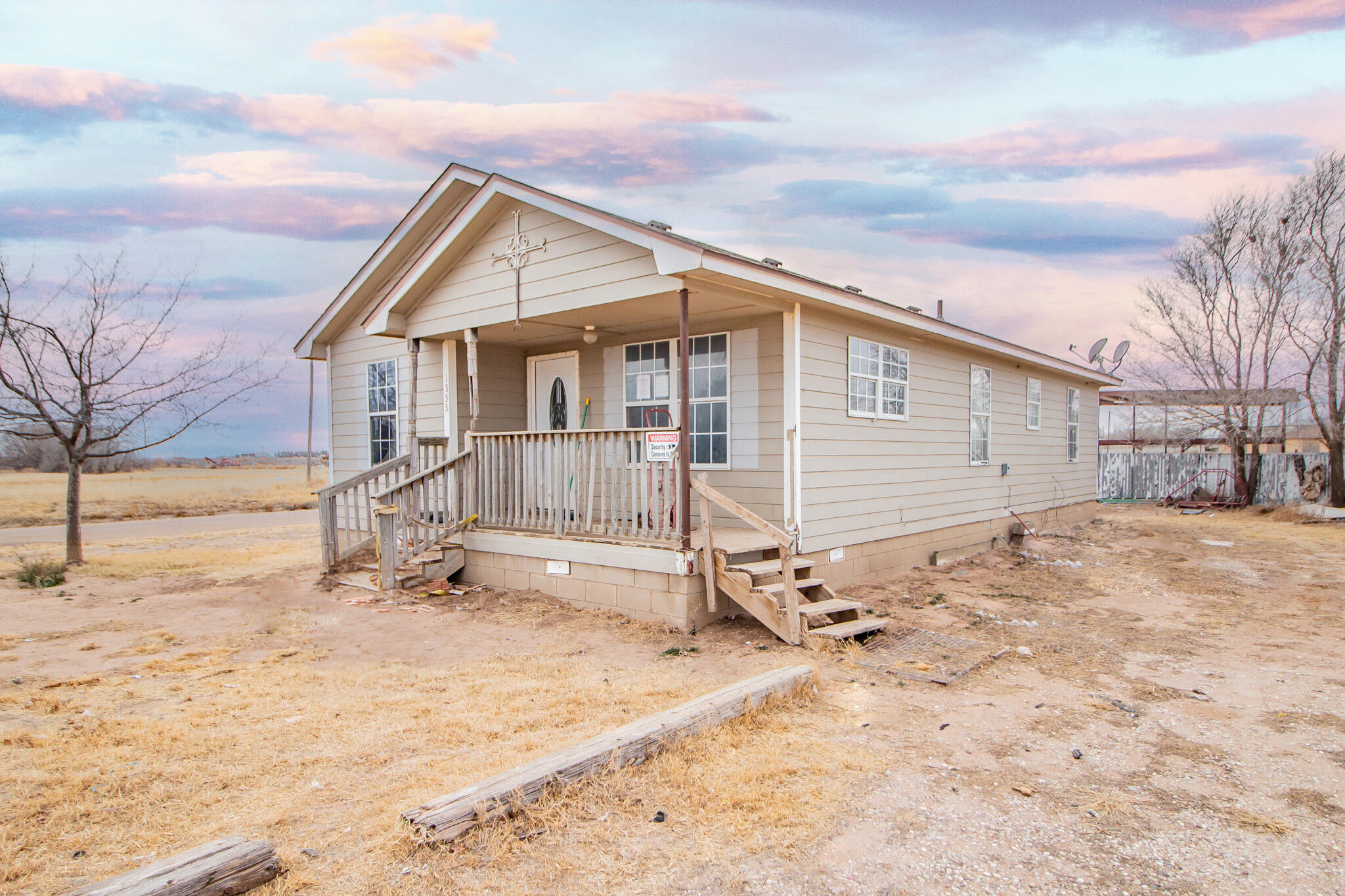 a view of a house with a yard covered in snow